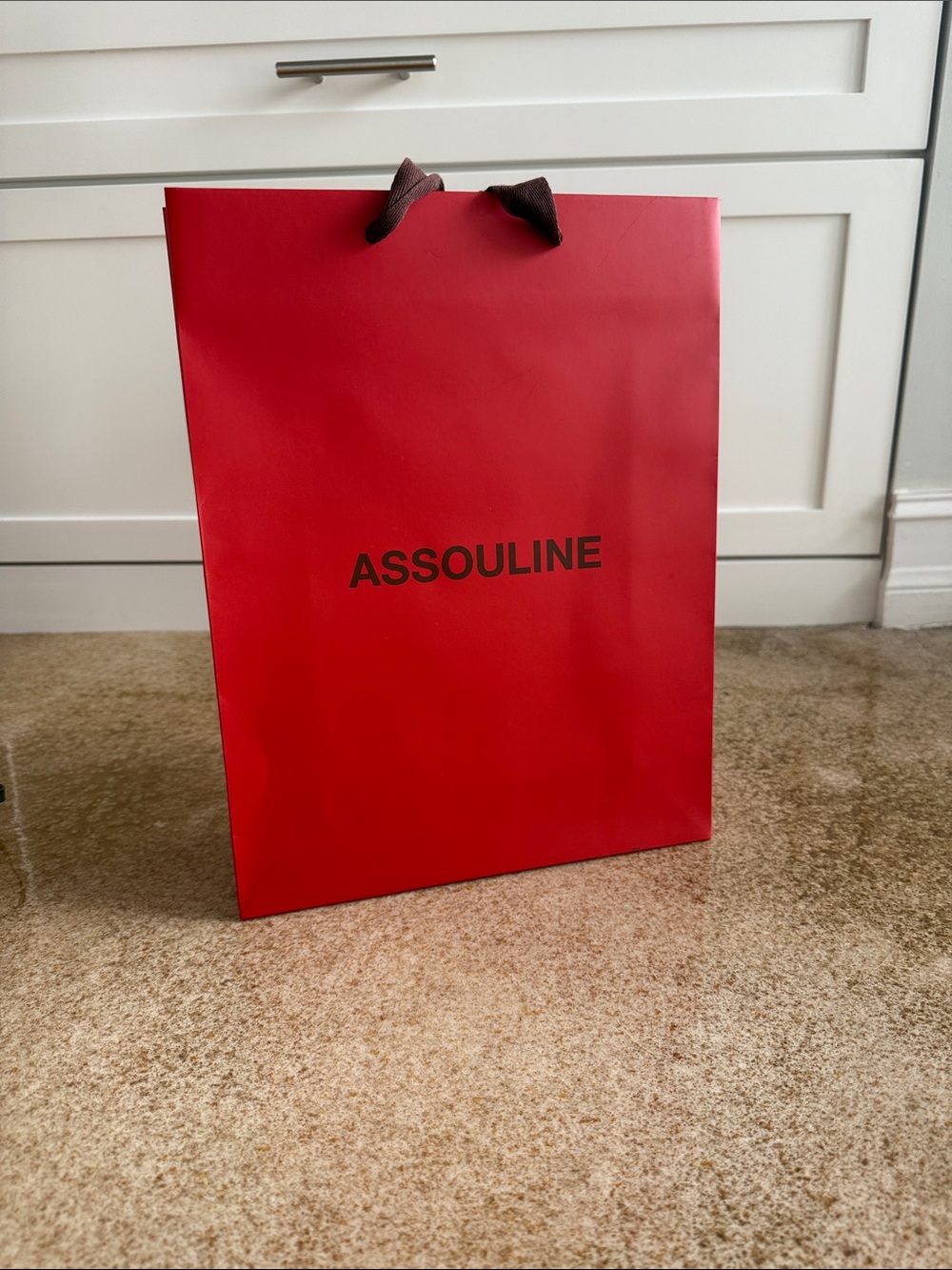 Assouline Red Gift Bag with dark brown Logo and Brown ribbon Handles